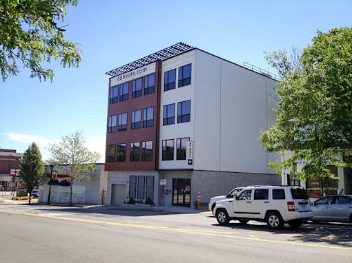 Modern four story building exterior with parking at 68 Beale Apartments, Quincy, 02169